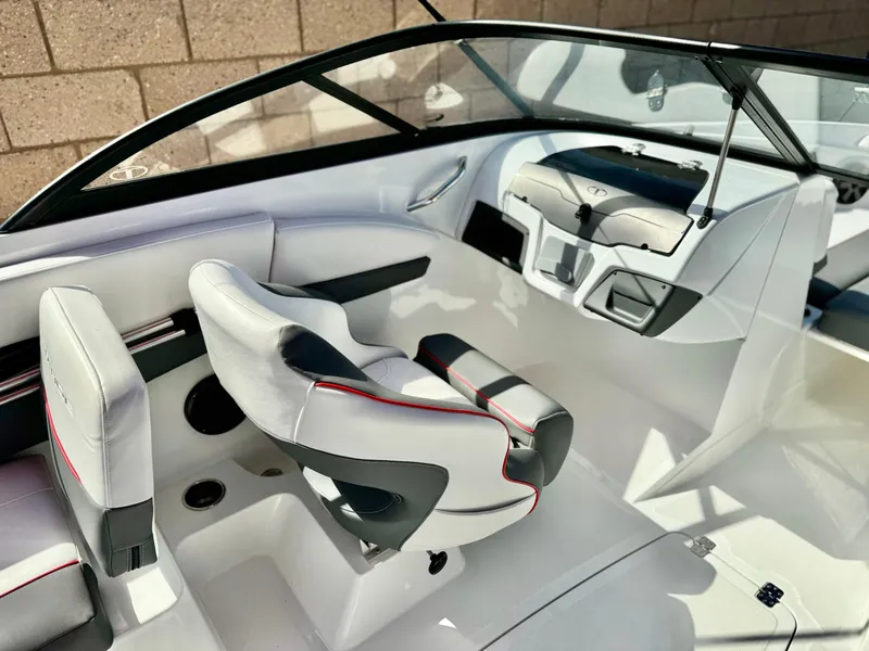 Slide: The Image of 2022 Tahoe 210 S boat interior with sleek white seating and modern dashboard design. - 10