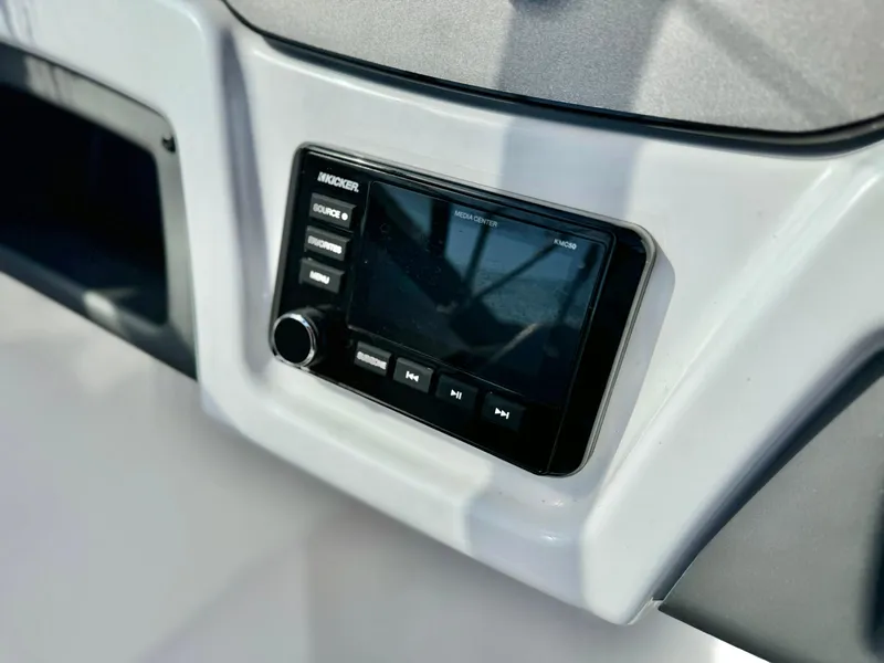 Slide: The Image of 2022 Tahoe 210 S boat dashboard with modern audio system. - 11