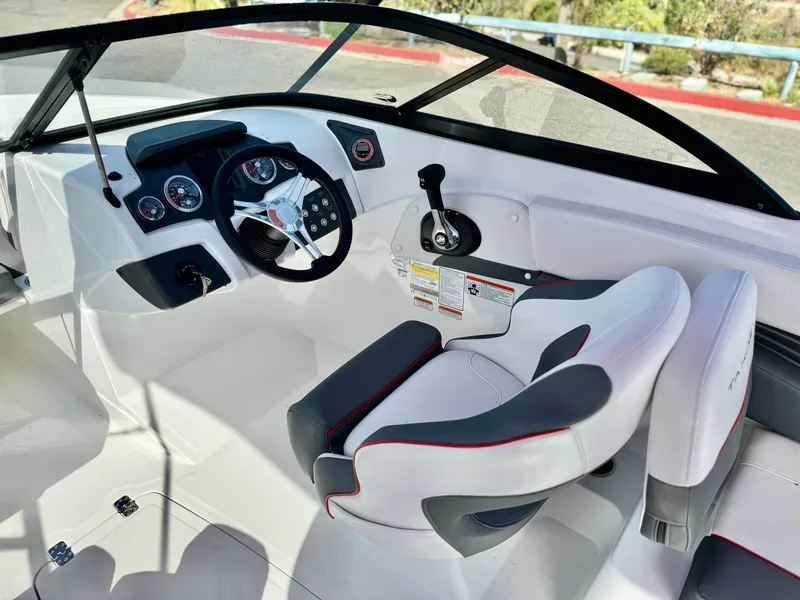 Slide: The Image of 2022 Tahoe 210 S boat interior with steering wheel and control panel. - 12