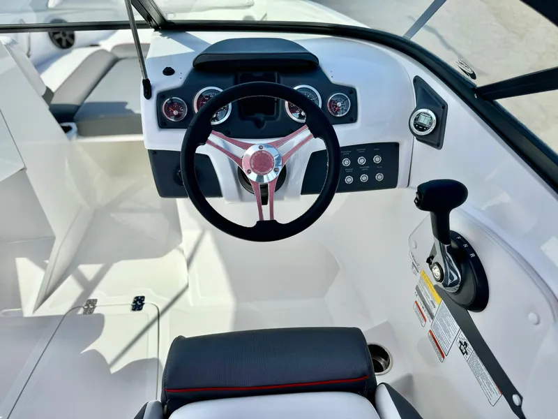 Slide: The Image of 2022 Tahoe 210 S boat cockpit with steering wheel and controls. - 13