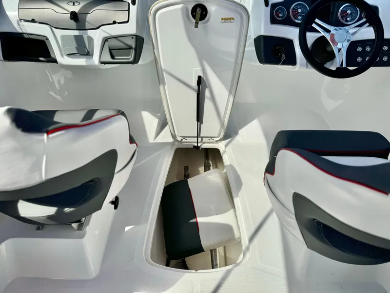 Slide: The Image of 2022 Tahoe 210 S boat interior with storage compartment and seating. - 15