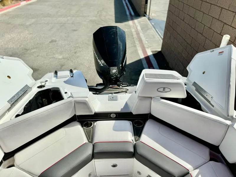 Slide: The Image of 2022 Tahoe 210 S boat interior with seating and outboard motor. - 18