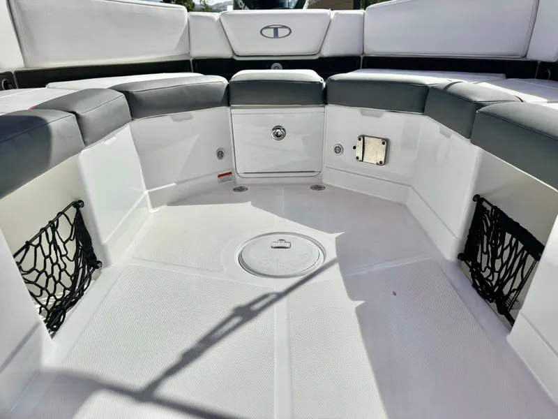 Slide: The Image of 2022 Tahoe 210 S boat interior with seating and storage compartments. - 19