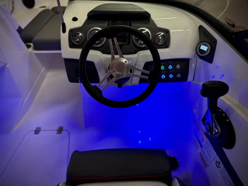 Slide: The Image of 2022 Tahoe 210 S boat cockpit with illuminated controls and steering wheel. - 22