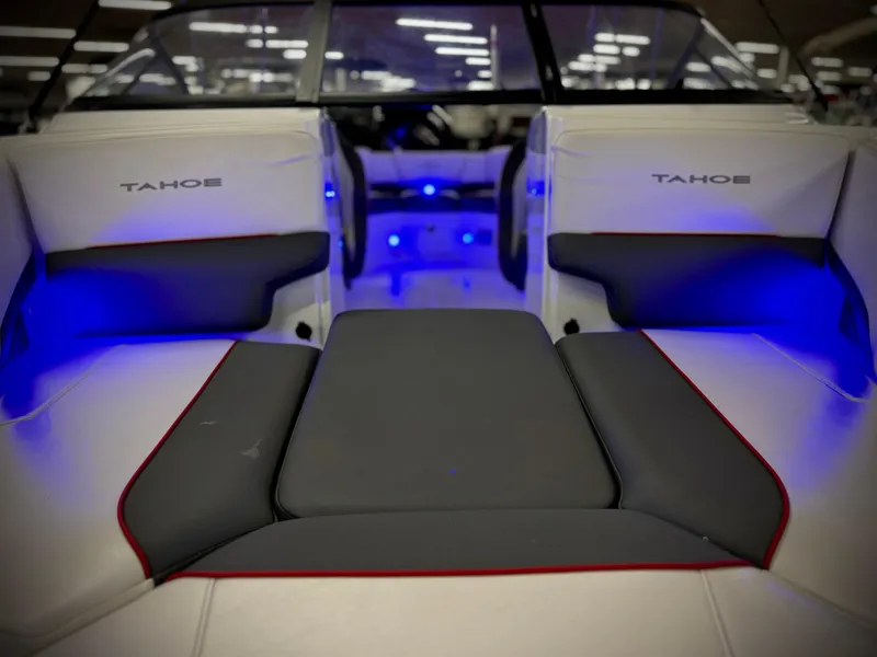 Slide: The Image of 2022 Tahoe 210 S boat interior with blue LED lighting and cushioned seating. - 24