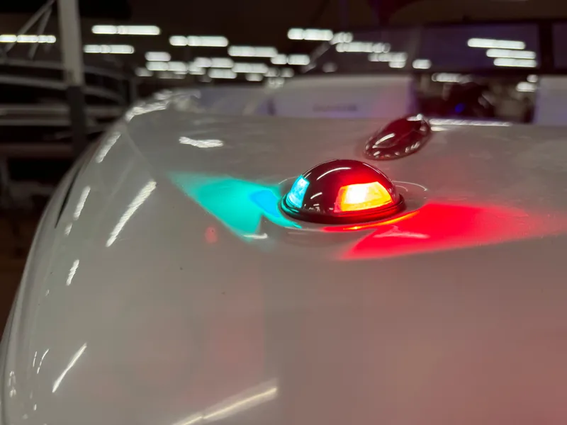 Slide: The Image of 2022 Tahoe 210 S boat with red and green navigation lights. - 25