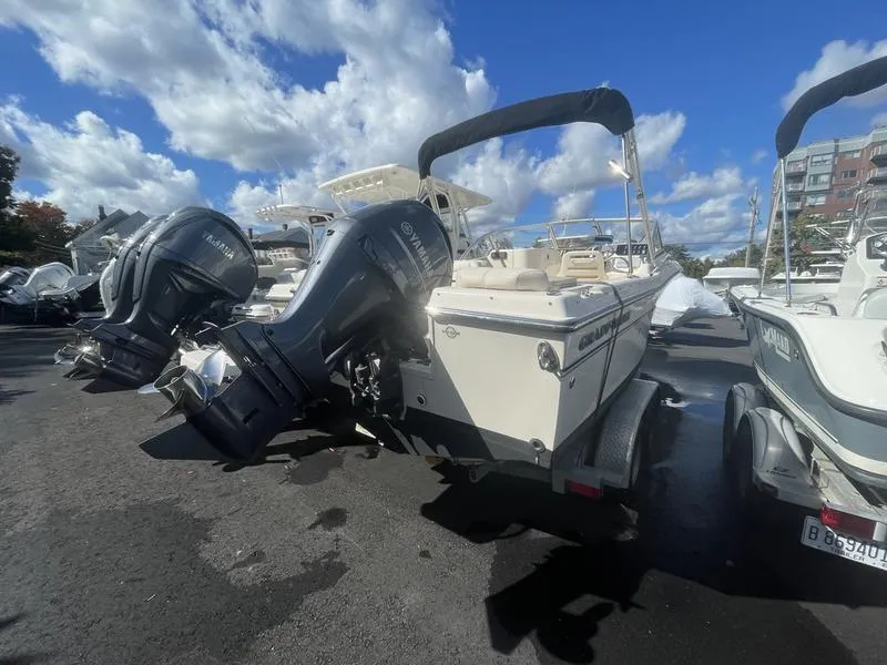 Slide: The Image of 2017 Grady-White 205 Freedom boat with dual outboard motors on a trailer. - 10
