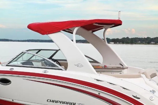 Slide: The Image of 2012 Chaparral 264 Sunesta boat with red canopy on a calm lake. - 14