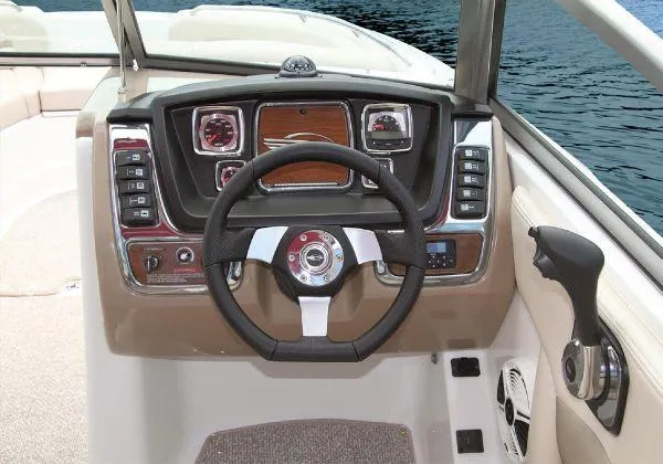 Slide: The Image of 2012 Chaparral 264 Sunesta boat dashboard with steering wheel and control panel. - 16