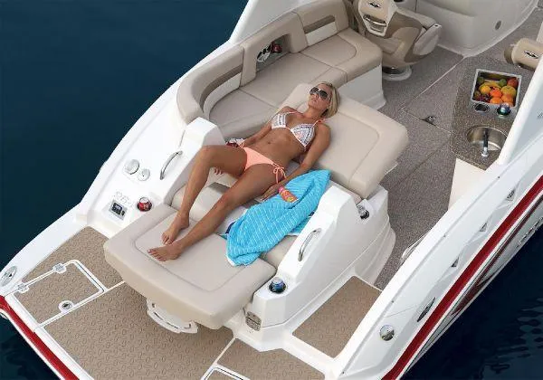 Slide: The Image of Woman relaxing on 2012 Chaparral 264 Sunesta boat, sunbathing on deck. - 20