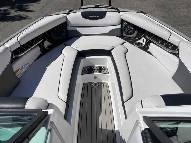 Slide: The Image of 2019 Nautique Super Air Nautique GS24 boat interior with sleek seating and cup holders. - 11