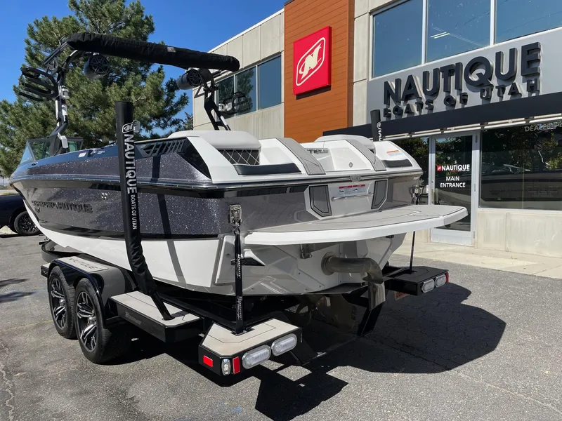 Slide: The Image of 2019 Nautique Super Air Nautique GS24 boat on trailer outside dealership. - 3