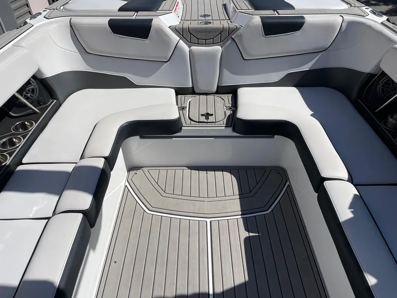 Slide: The Image of 2019 Nautique Super Air Nautique GS24 interior with gray seating and flooring. - 8