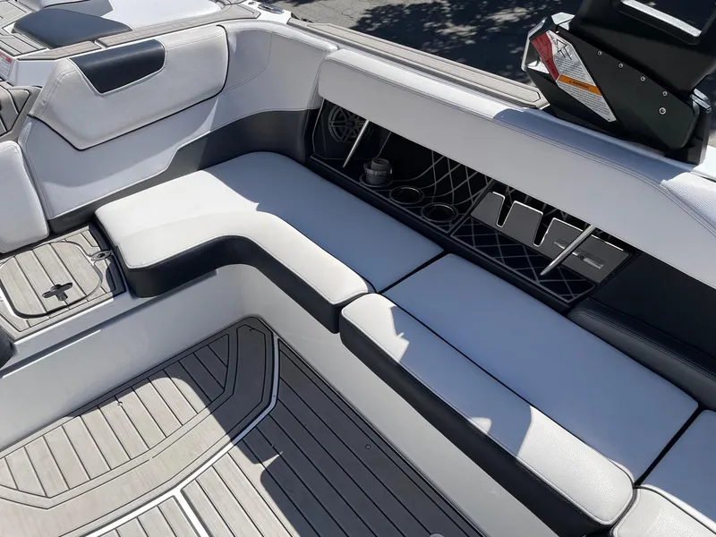 Slide: The Image of 2019 Nautique Super Air Nautique GS24 interior seating with sleek, modern design and storage compartments. - 9