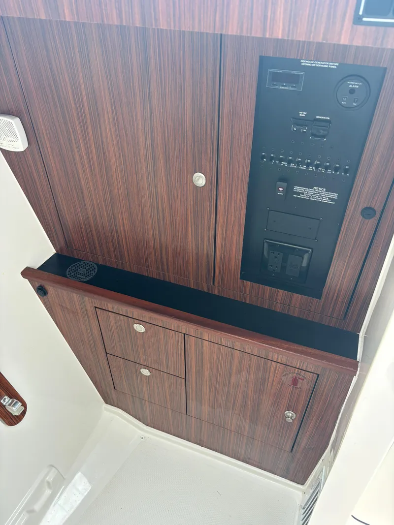 Slide: The Image of 2020 Pursuit 325 Dual Console interior control panel with wood finish. - 23