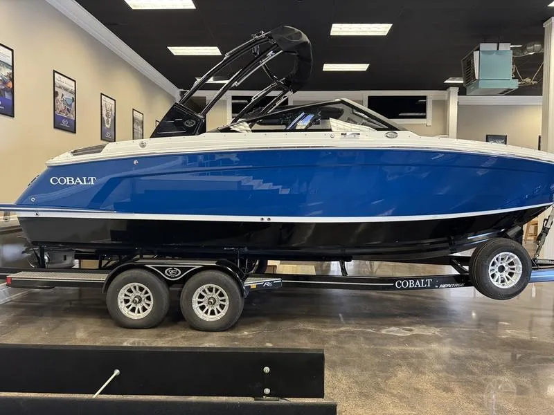 Slide: The Image of 2025 Cobalt R6 boat in showroom, blue and white design on trailer. - 18