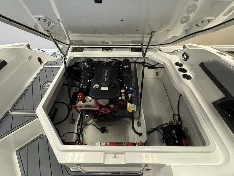 Slide: The Image of 2025 Cobalt R6 boat engine compartment with open hatch, showcasing engine and components. - 21