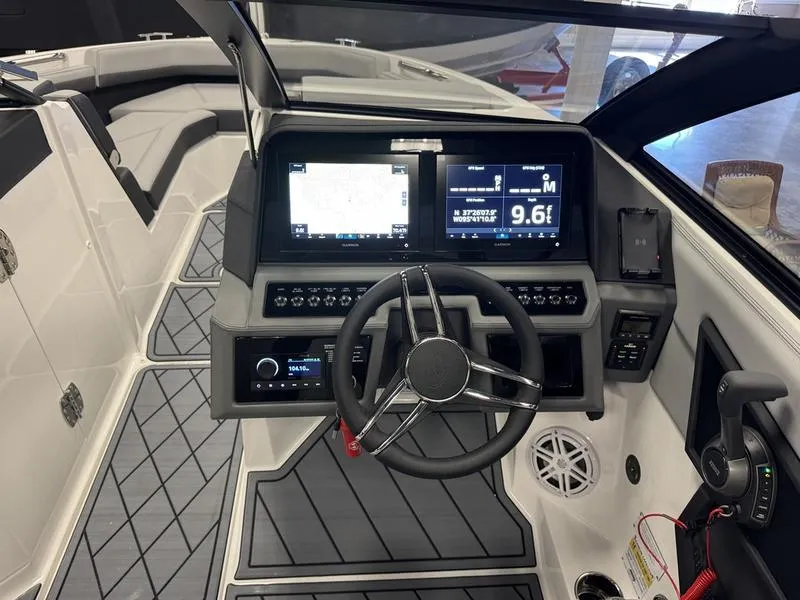 Slide: The Image of 2025 Cobalt R6 boat dashboard with modern navigation screens and steering wheel. - 3