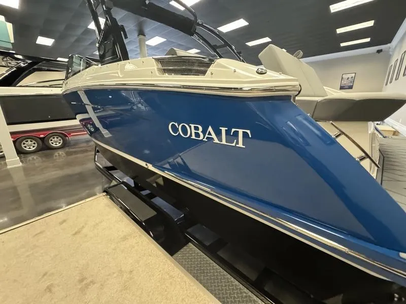 Slide: The Image of 2025 Cobalt R6 boat in showroom, blue exterior, sleek design. - 6