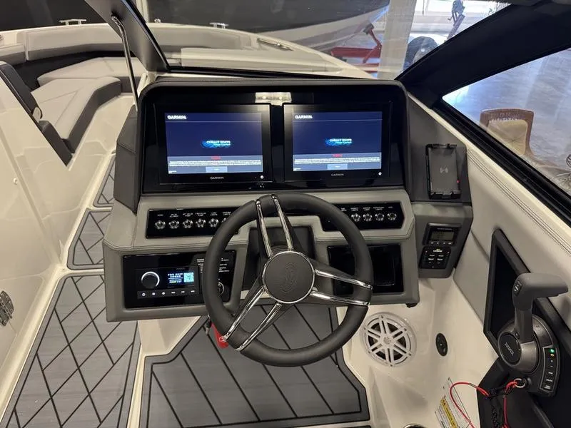 Slide: The Image of 2025 Cobalt R6 boat dashboard with dual screens and modern steering wheel. - 8