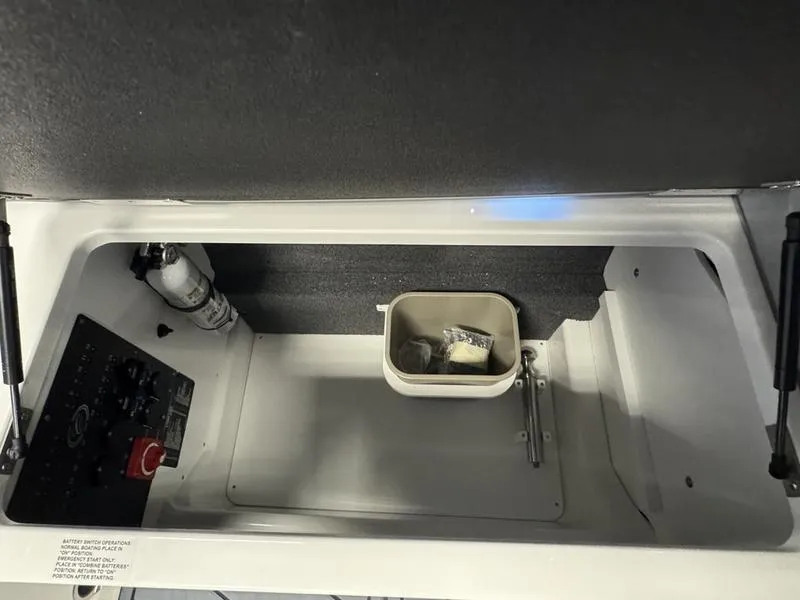 Slide: The Image of 2025 Cobalt R6 storage compartment with control panel and small container. - 9