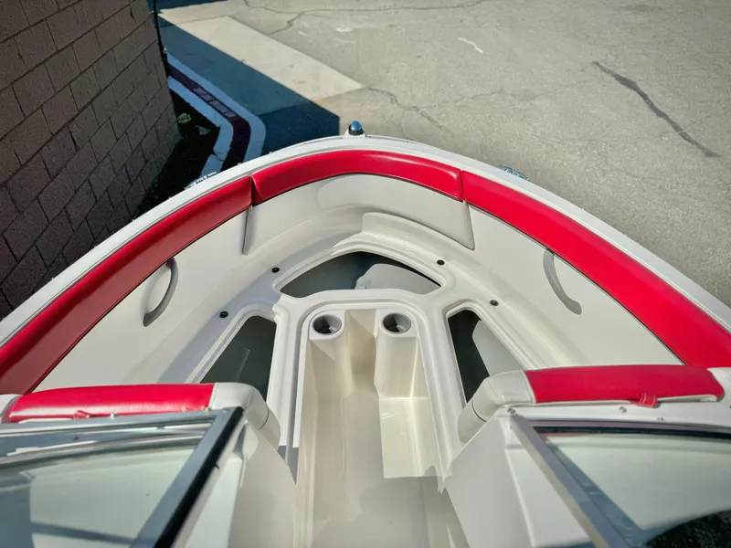 Slide: The Image of 2013 Bayliner 185 Bowrider boat interior with red and white seating. - 10