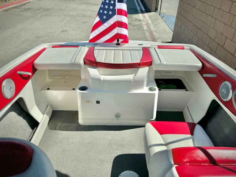 Slide: The Image of 2013 Bayliner 185 Bowrider interior with red and white seating, American flag displayed. - 17