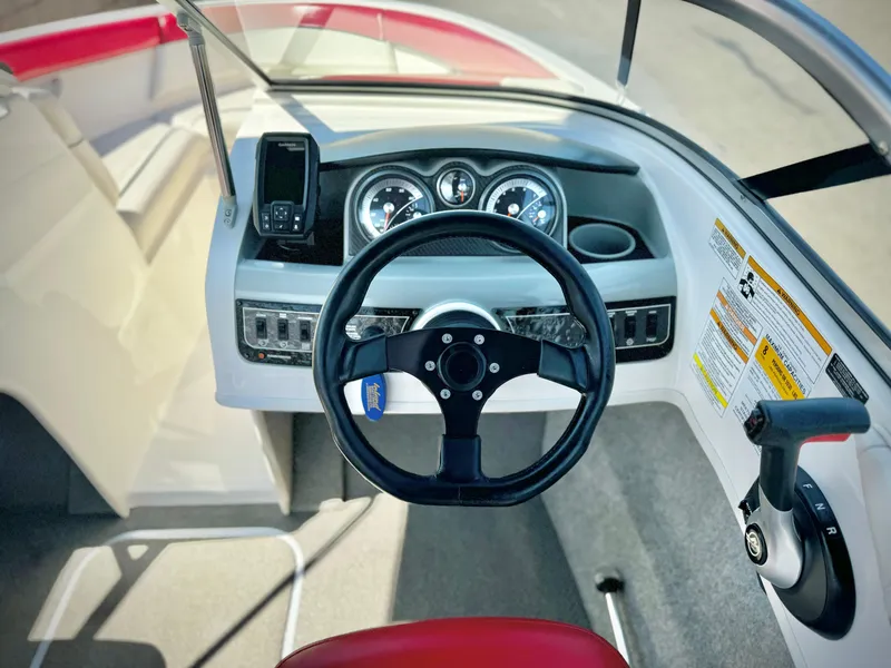 Slide: The Image of 2013 Bayliner 185 Bowrider dashboard with steering wheel and controls. - 20