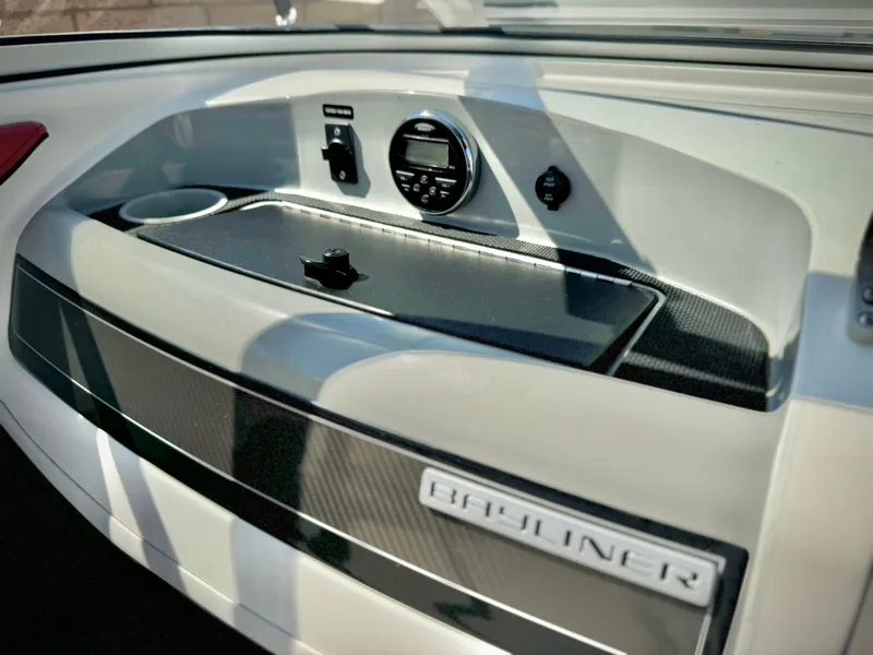 Slide: The Image of 2013 Bayliner 185 Bowrider dashboard with control panel and storage compartment. - 22