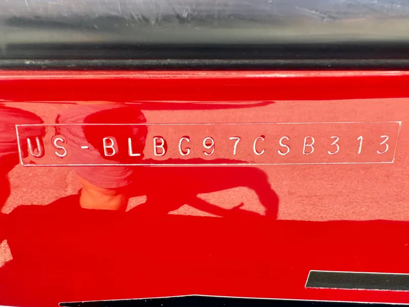 Slide: The Image of 2013 Bayliner 185 Bowrider hull identification number on red surface. - 24