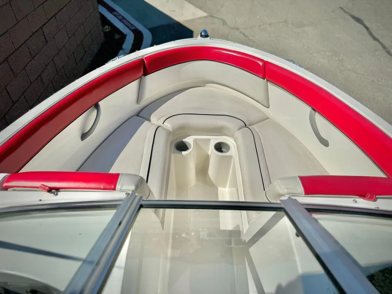 Slide: The Image of 2013 Bayliner 185 Bowrider interior with red and white seating. - 9