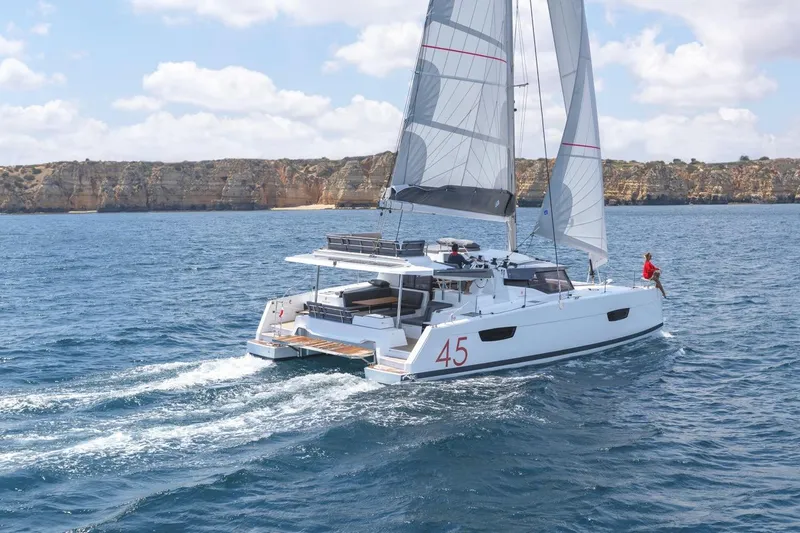 Slide: The Image of 2025 Fountaine Pajot Elba 45 catamaran sailing on open sea. - 12