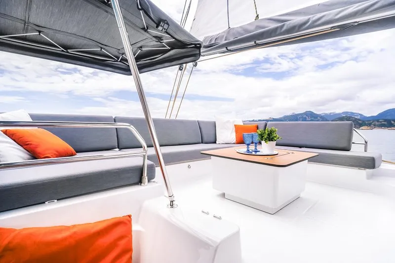 Slide: The Image of Luxurious 2025 Fountaine Pajot Tanna 47 yacht with elegant seating and scenic ocean view. - 13
