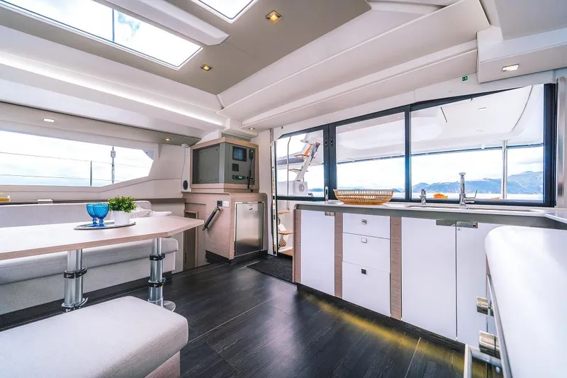 Slide: The Image of Luxurious interior of 2025 Fountaine Pajot Tanna 47 catamaran with modern kitchen and dining area. - 18