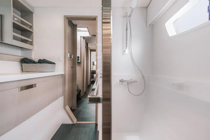 Slide: The Image of 2025 Fountaine Pajot Tanna 47 yacht interior, featuring modern bathroom and sleek design. - 8