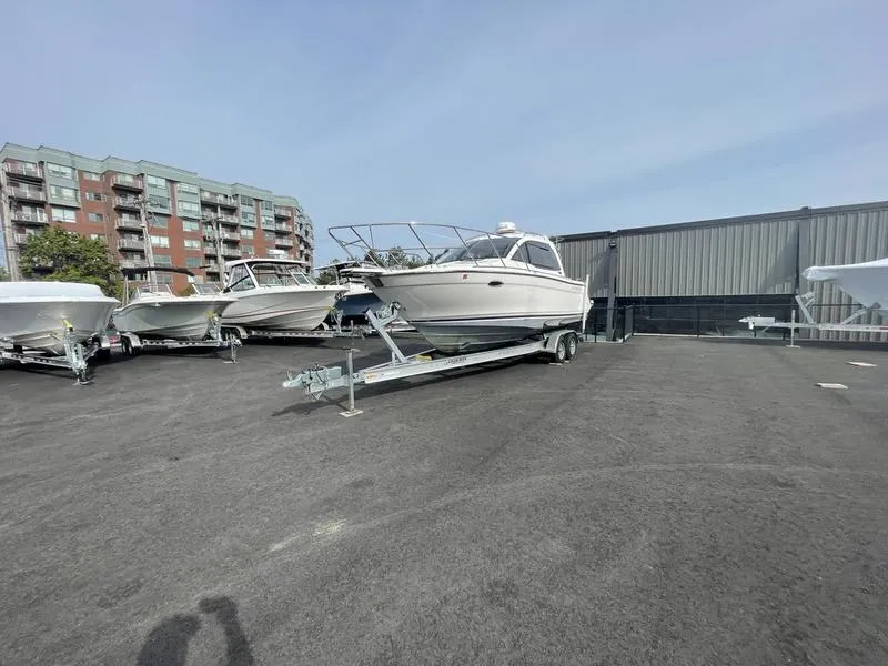 Slide: The Image of 2022 Cutwater C-248 boat on trailer in parking lot near buildings. - 1