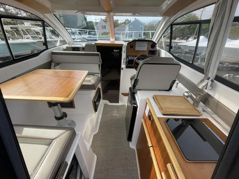 Slide: The Image of Interior of 2022 Cutwater C-248 boat with seating, table, and helm station. - 10