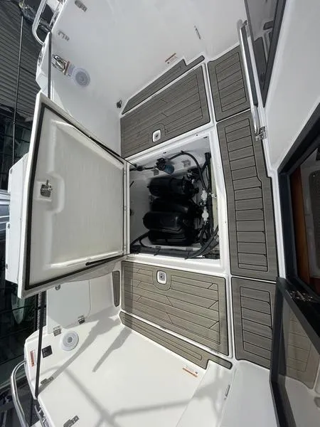 Slide: The Image of 2022 Cutwater C-248 boat engine compartment with open hatch and deck view. - 2