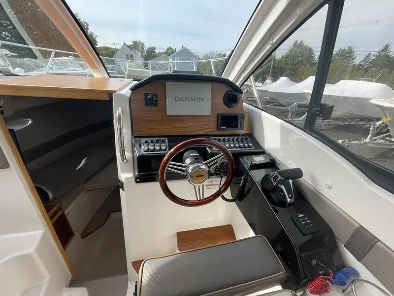 Slide: The Image of 2022 Cutwater C-248 boat cockpit with Garmin navigation system and steering wheel. - 3
