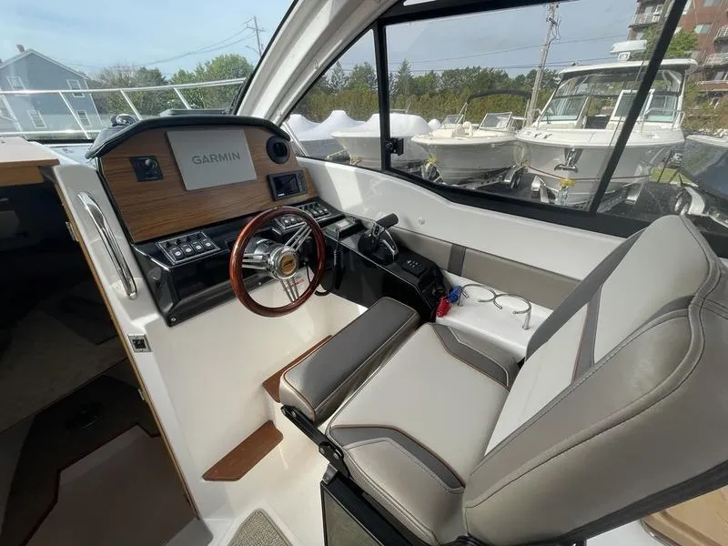 Slide: The Image of 2022 Cutwater C-248 boat interior with Garmin navigation, sleek helm, and comfortable seating. - 4
