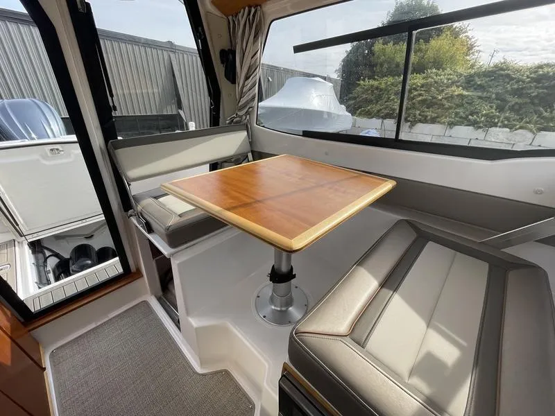 Slide: The Image of Interior of 2022 Cutwater C-248 boat with seating and wooden table. - 7