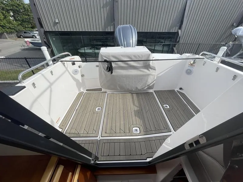 Slide: The Image of 2022 Cutwater C-248 boat deck with wood flooring and covered engine. - 9