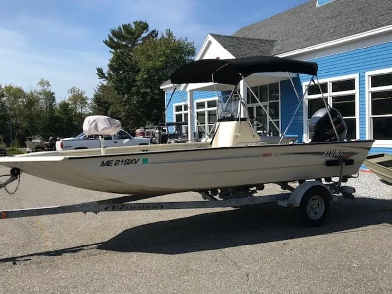 Slide: The Image of 2017 Alumacraft 2072 Bay boat on trailer, parked near blue building. - 3