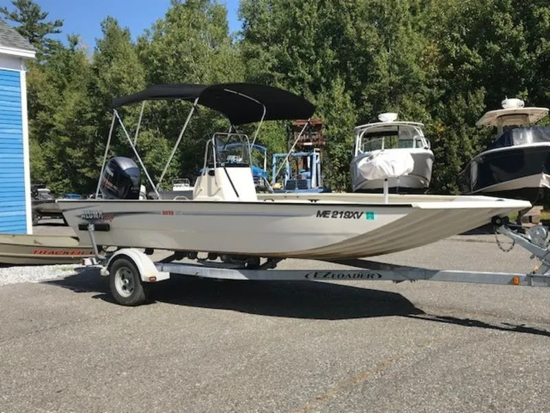 Slide: The Image of 2017 Alumacraft 2072 Bay boat on trailer, parked outdoors near trees and other boats. - 4