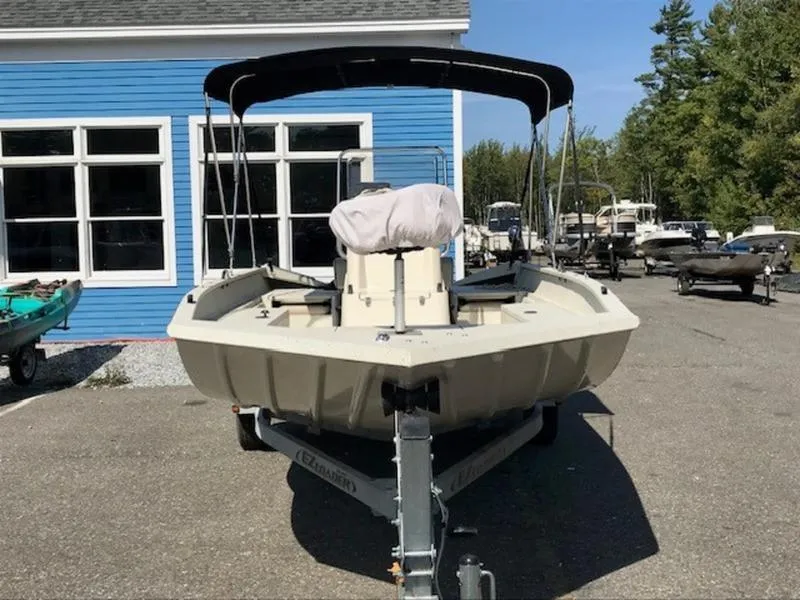 Slide: The Image of 2017 Alumacraft 2072 Bay boat on trailer, parked near blue building. - 5