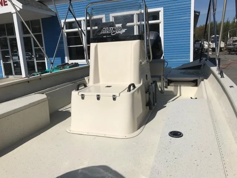 Slide: The Image of 2017 Alumacraft 2072 Bay boat with center console, docked near blue building. - 6