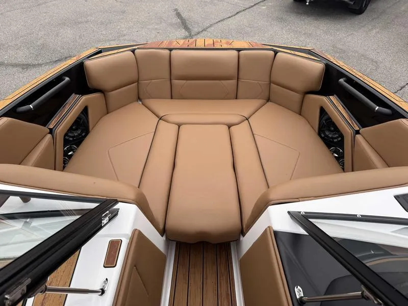 Slide: The Image of 2025 Moomba Tykon boat interior with tan leather seating and wood accents. - 15