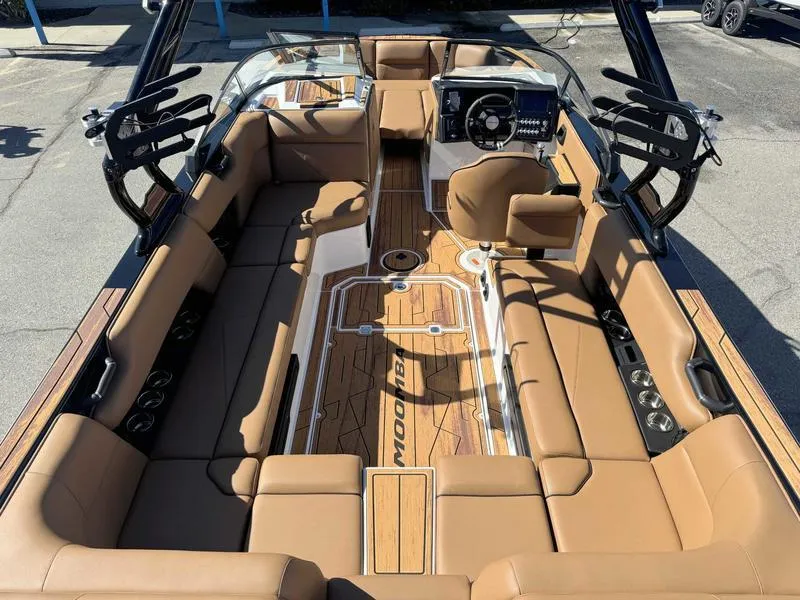 Slide: The Image of 2025 Moomba Tykon boat interior with tan seating and modern dashboard. - 3