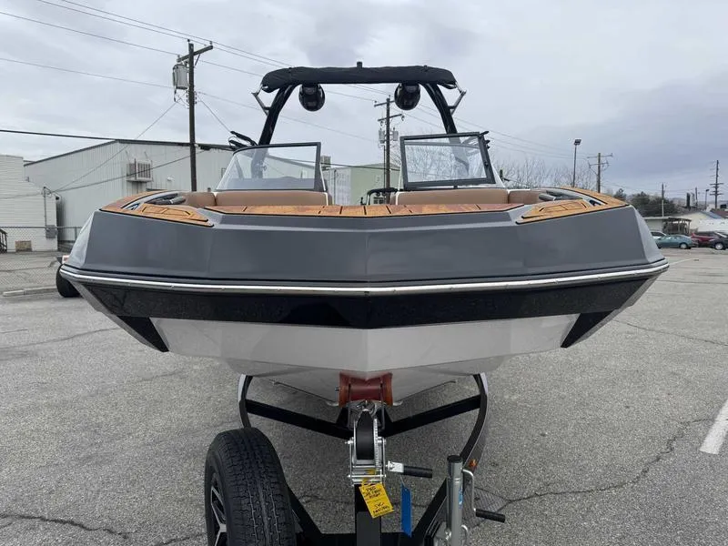 Slide: The Image of 2025 Moomba Tykon boat on trailer, front view, parked in industrial area. - 4