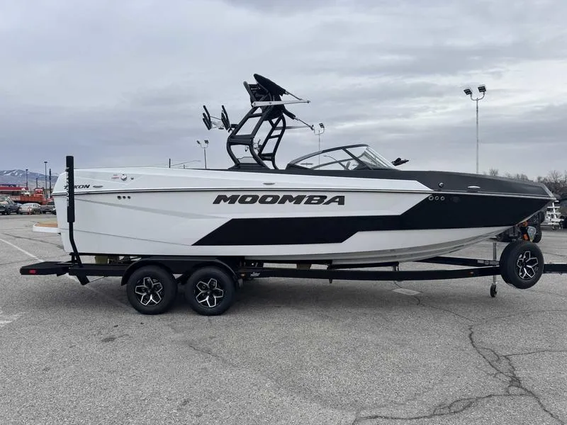 Slide: The Image of 2025 Moomba Tykon boat on trailer in parking lot, overcast sky. - 6